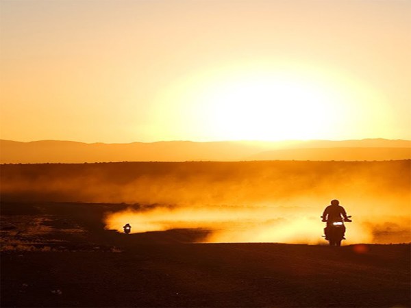 Motorbikes riding in the sunset